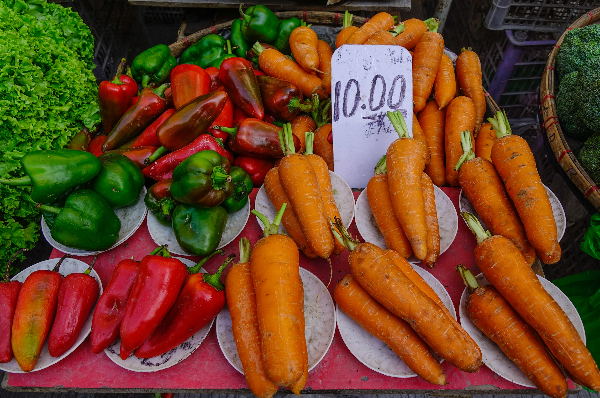 Customers buy fruits and vegetables in a street grocery shop in Manila Customers buy fruits and vegetables in a street grocery shop in Manila