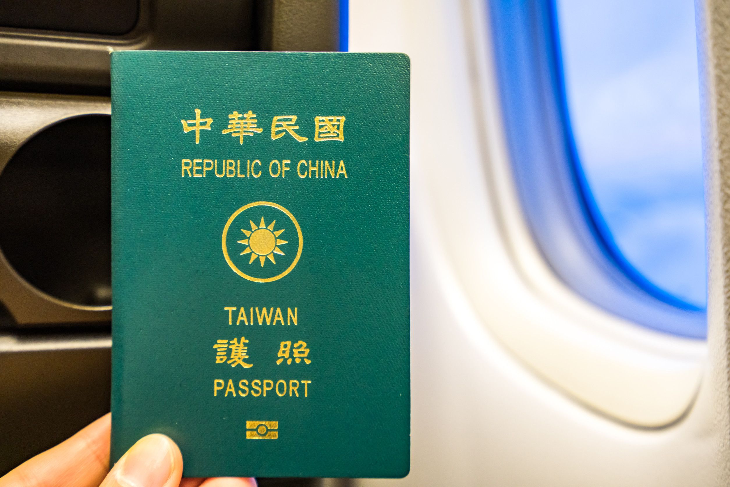 Taiwan passport near airplane window